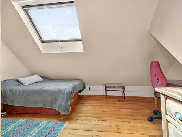 a bedroom with a bed and window