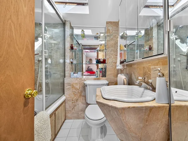 a bathroom with a sink toilet and shower