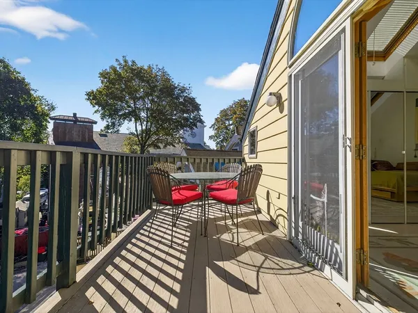 a view of a chairs and table in the balcony