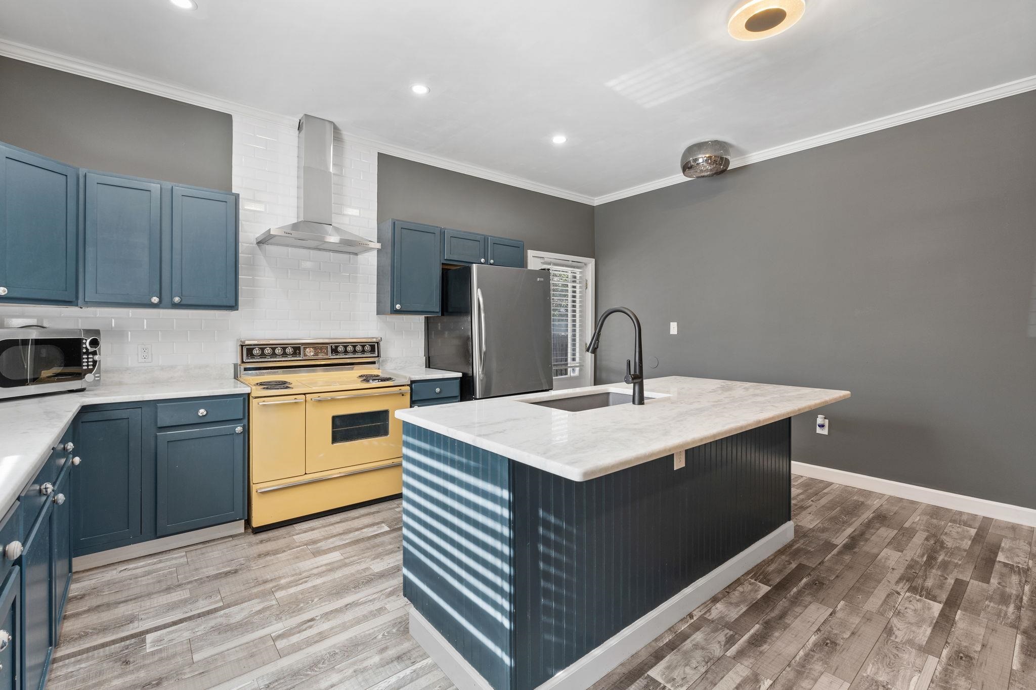 710 Philadelphia Street Memphis, TN 38104 - Photo 5 of 25 a kitchen with a sink stove and refrigerator