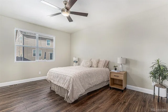 a bedroom with a bed and a potted plant