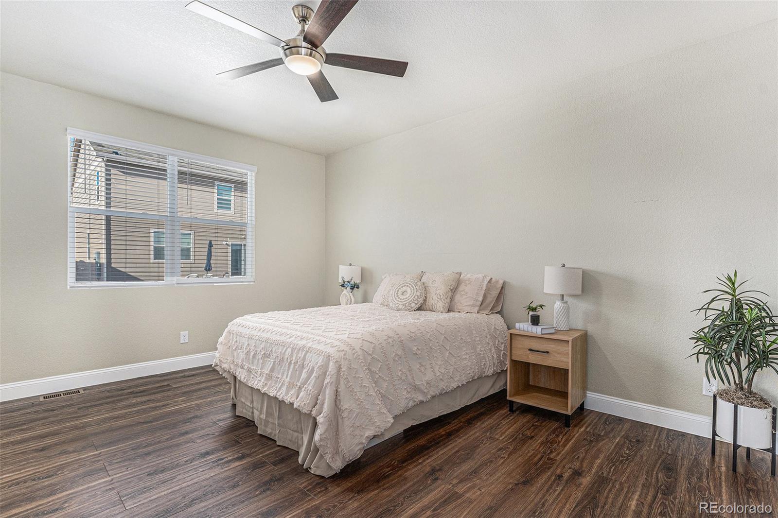 1051 Draw Street Brighton, CO 80603 - Photo 11 of 19 a bedroom with a bed and a potted plant
