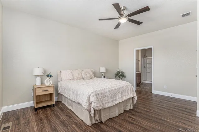 a bedroom with a bed and a ceiling fan