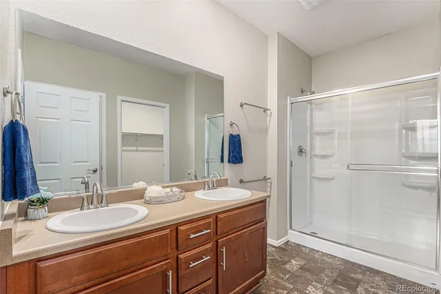 a bathroom with a double vanity sink mirror double and shower