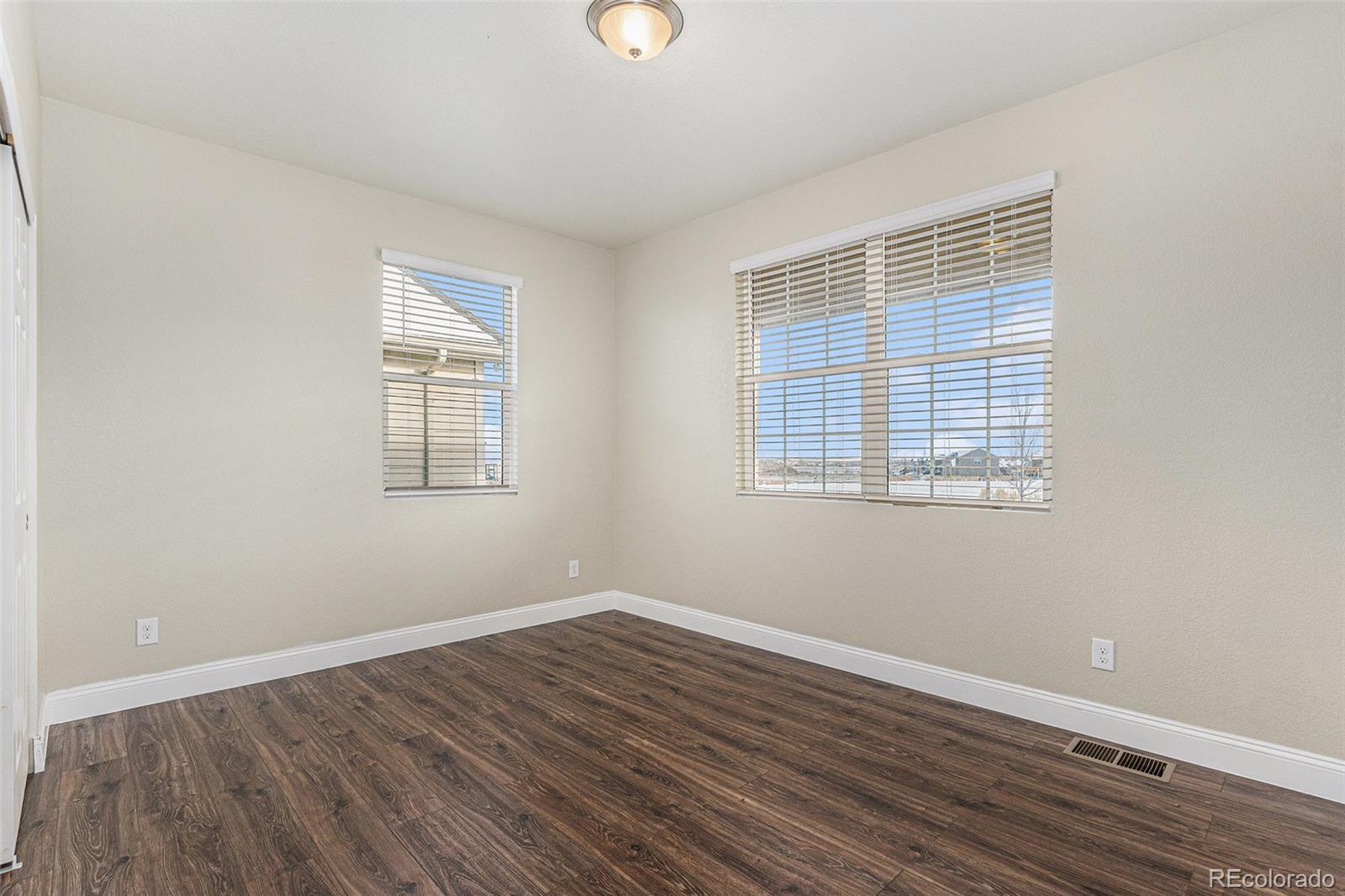 1051 Draw Street Brighton, CO 80603 - Photo 16 of 19 a view of a room with wooden floor and windows