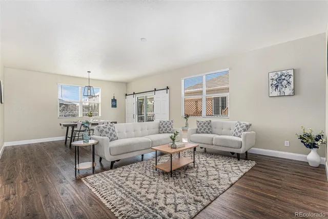 a living room with furniture and wooden floor