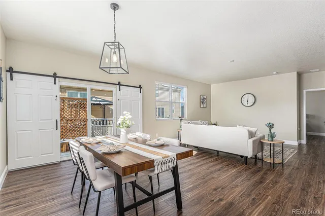 a view of a dining room with furniture window and wooden floor