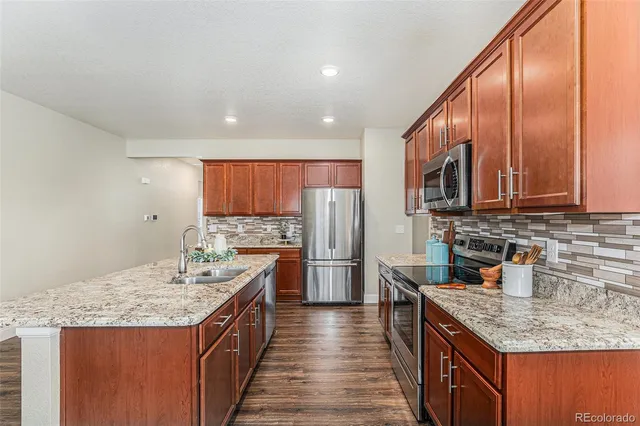 a kitchen with a sink stove and refrigerator