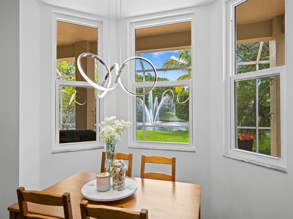 301 Cameron Drive Weston, FL 33326 - Photo 17 of 39 a dining room with furniture and a window