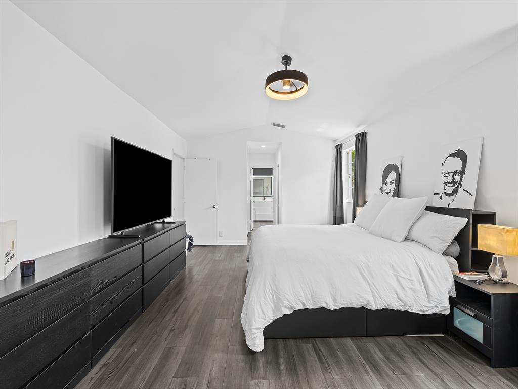 301 Cameron Drive Weston, FL 33326 - Photo 18 of 39 a bedroom with a bed and a flat screen tv