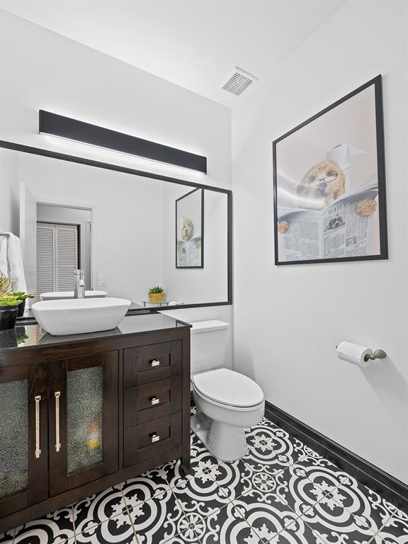 301 Cameron Drive Weston, FL 33326 - Photo 30 of 39 a bathroom with a toilet a sink and mirror