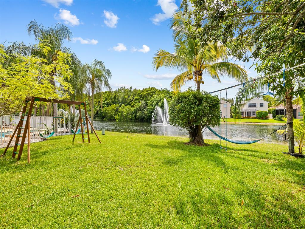 301 Cameron Drive Weston, FL 33326 - Photo 35 of 39 a view of swimming pool with a yard and palm trees