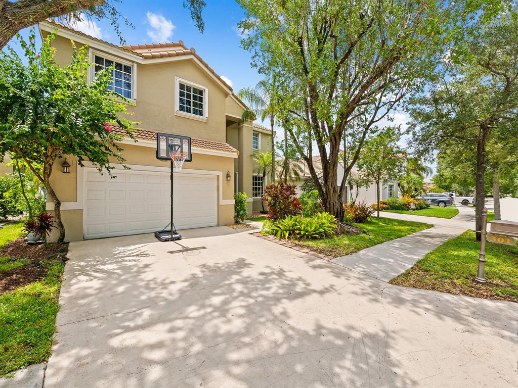 301 Cameron Drive Weston, FL 33326 - Photo 6 of 39 a view of a yard with plants and trees