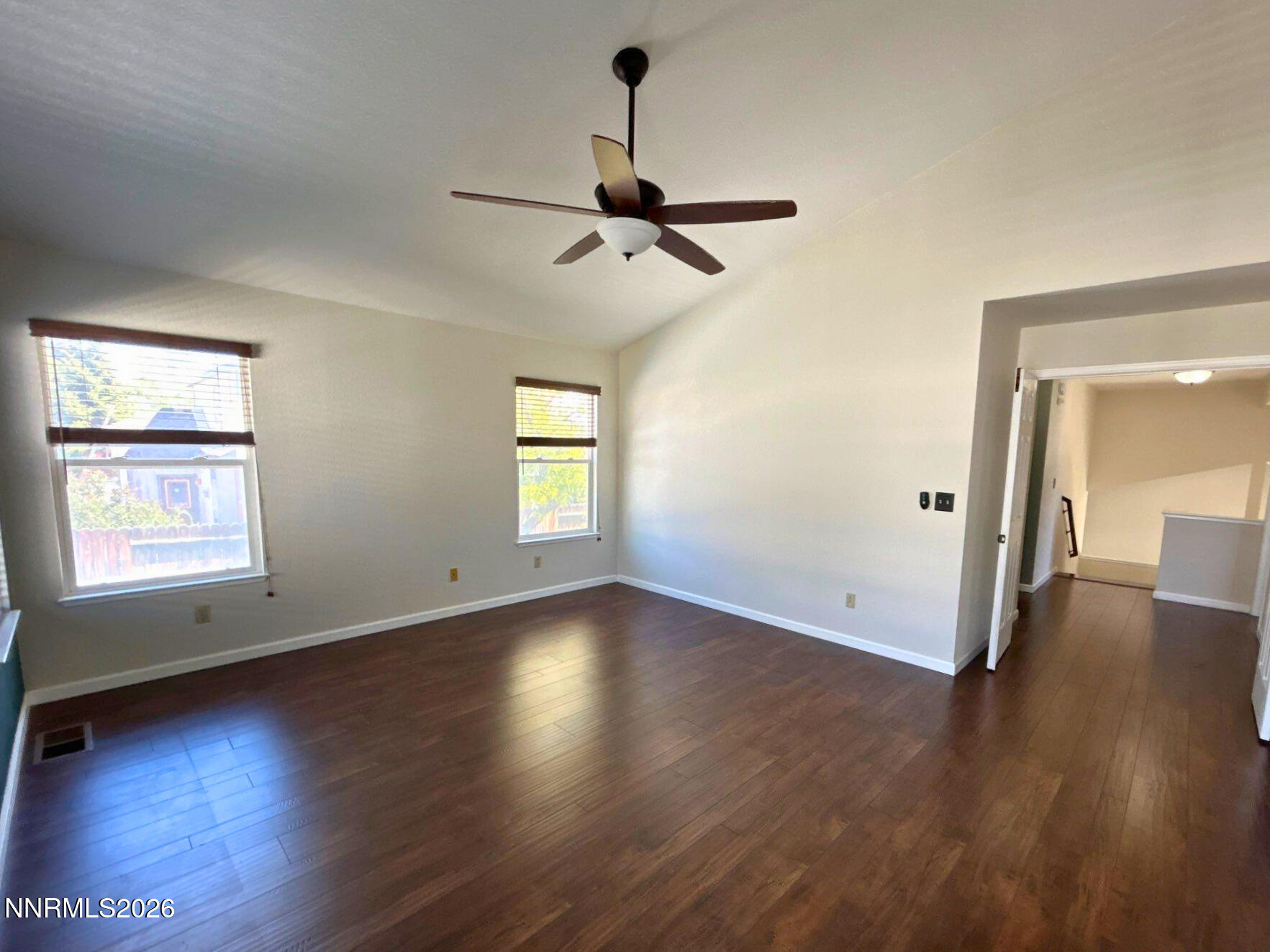 4437 Highplains Drive Reno, NV 89523 - Photo 11 of 19 an empty room with wooden floor chandelier and windows