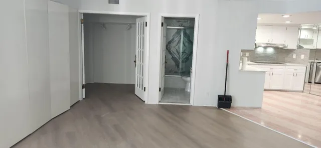 a view of a kitchen cabinets and wooden floor