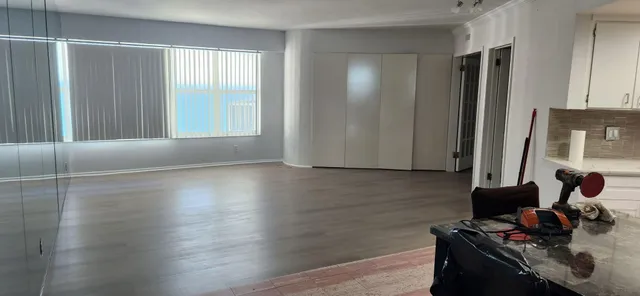 a room with wooden floor and furniture