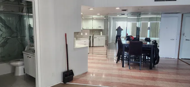 a dining room with furniture and wooden floor