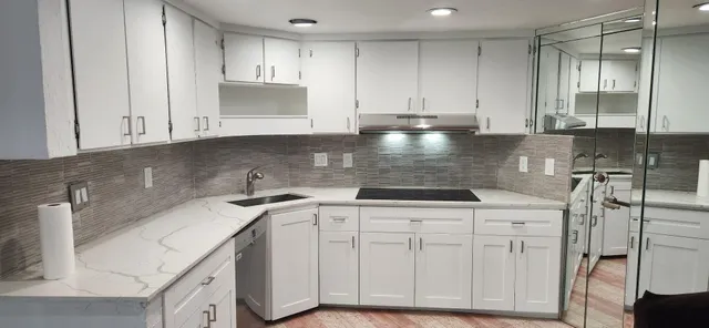 a kitchen with stainless steel appliances granite countertop a sink stove and cabinets