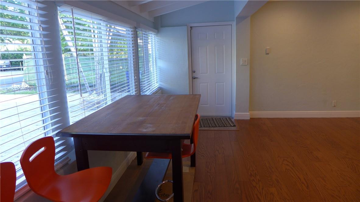 809 North Victoria Park Road Fort Lauderdale, FL 33304 - Photo 14 of 25 a view of a dining room with furniture and wooden floor