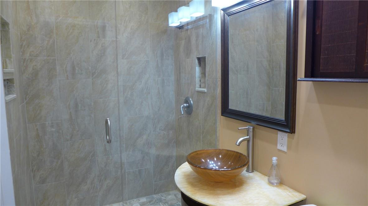 809 North Victoria Park Road Fort Lauderdale, FL 33304 - Photo 15 of 25 a bathroom with a sink and a mirror