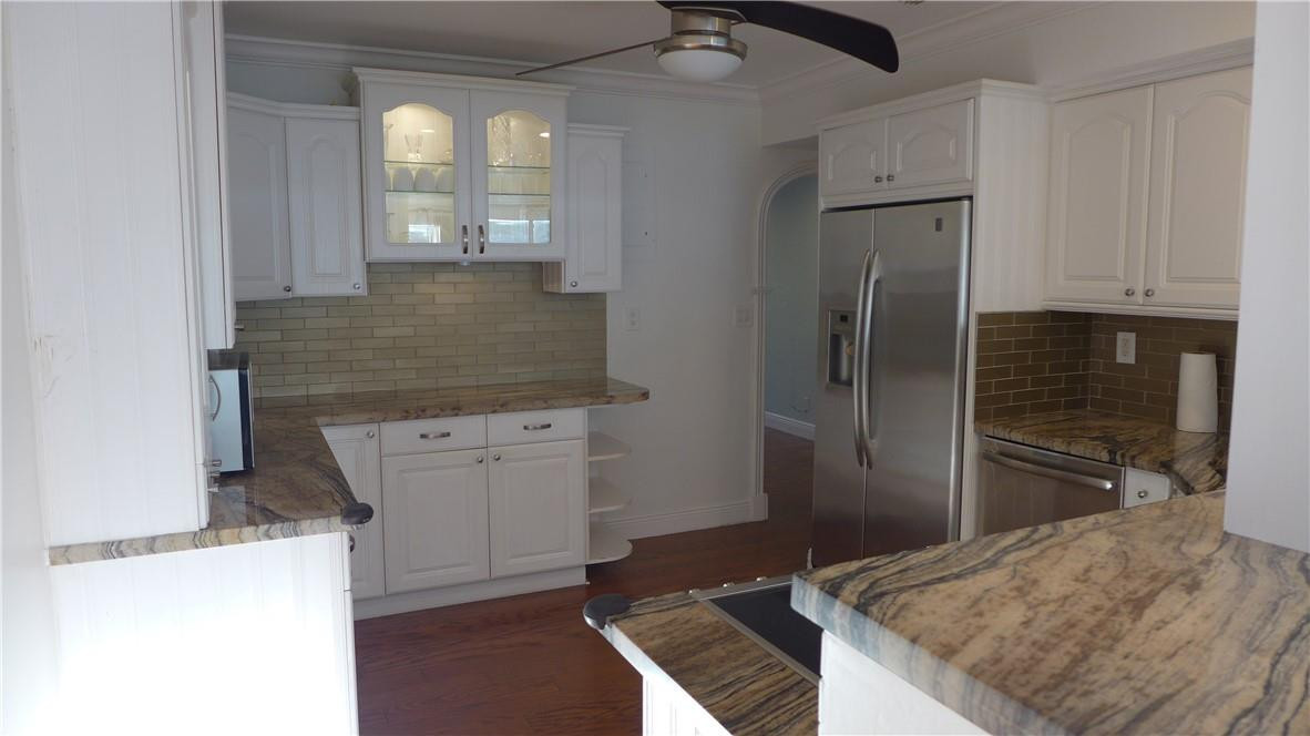 809 North Victoria Park Road Fort Lauderdale, FL 33304 - Photo 2 of 25 a kitchen with stainless steel appliances granite countertop a refrigerator and a stove