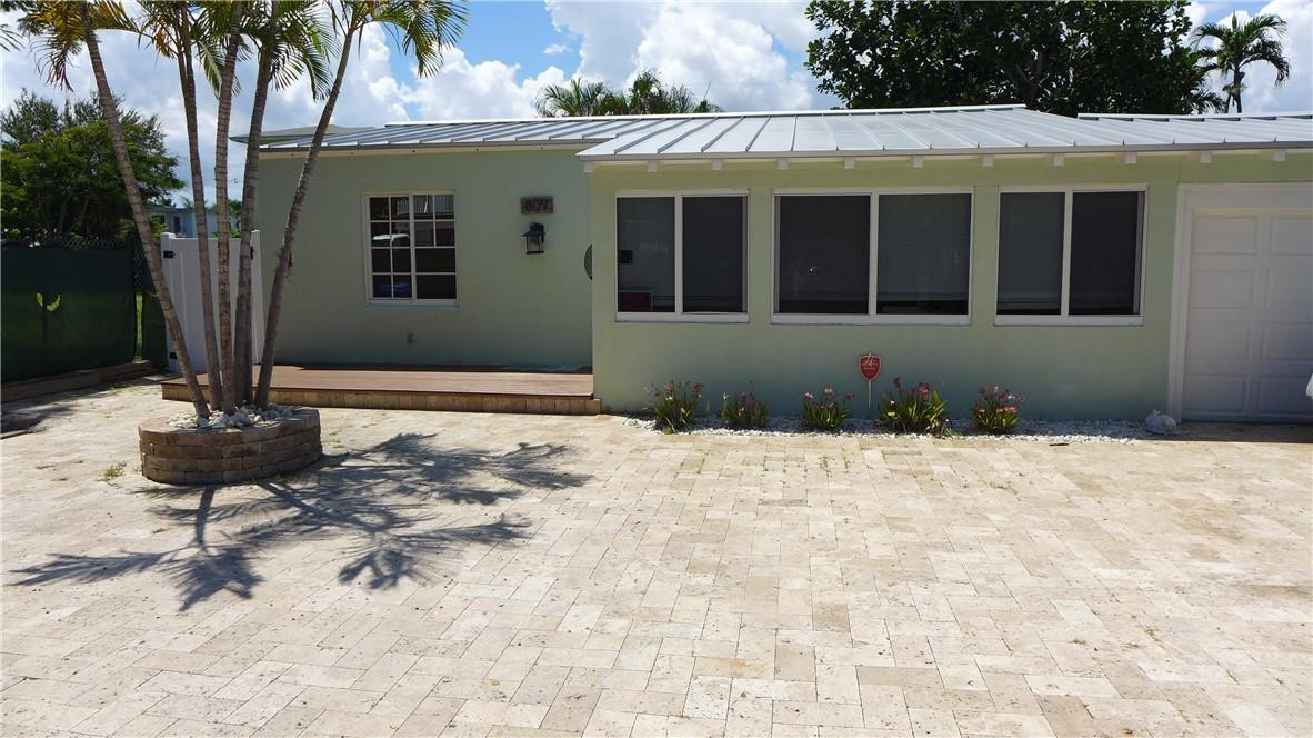 809 North Victoria Park Road Fort Lauderdale, FL 33304 - Photo 24 of 25 a front view of a house with a yard