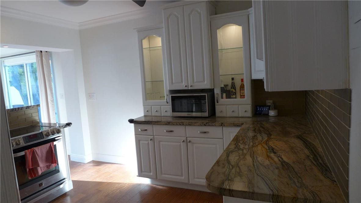 809 North Victoria Park Road Fort Lauderdale, FL 33304 - Photo 5 of 25 a kitchen with granite countertop a sink and a microwave