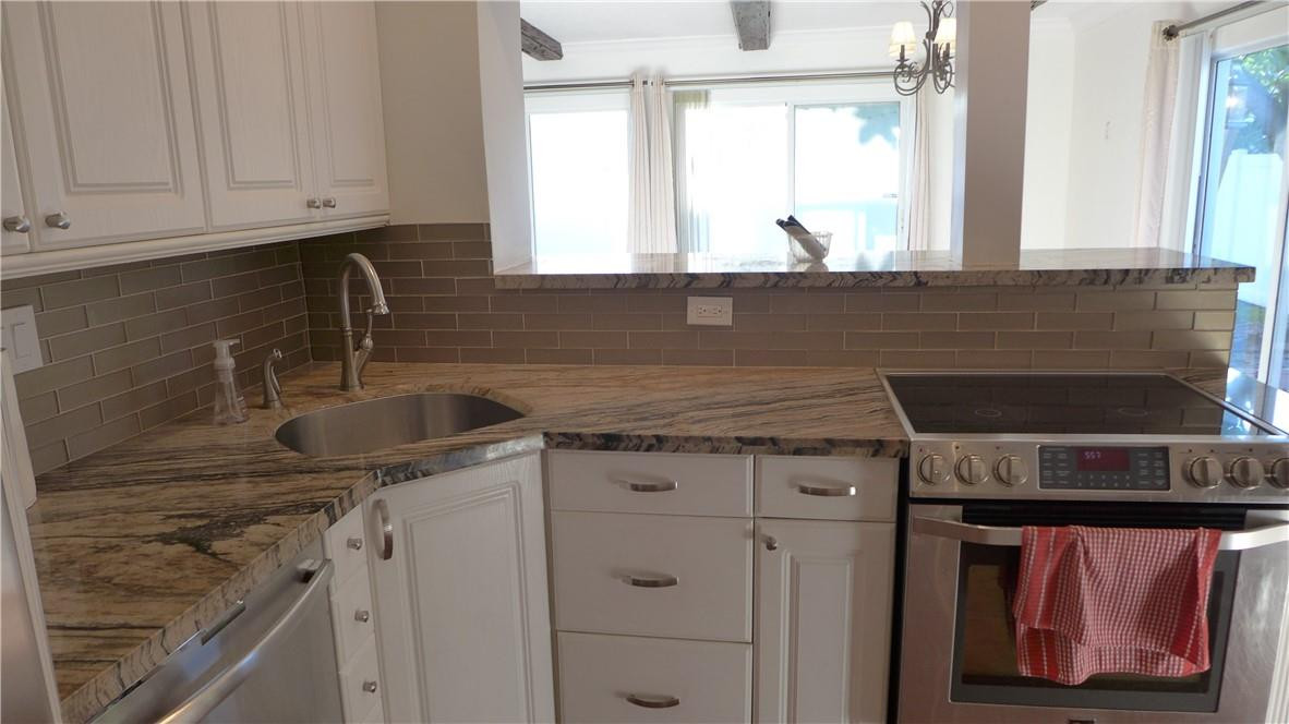 809 North Victoria Park Road Fort Lauderdale, FL 33304 - Photo 6 of 25 a kitchen with granite countertop a sink stove and cabinets