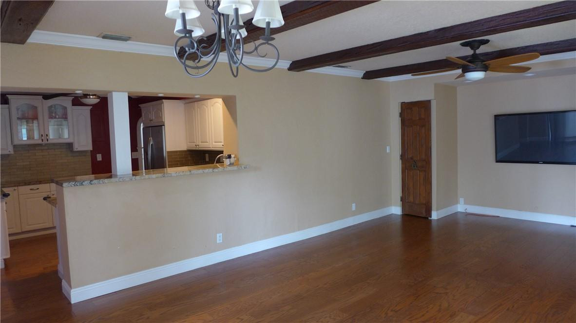 809 North Victoria Park Road Fort Lauderdale, FL 33304 - Photo 7 of 25 a view of a hallway with wooden floor and chandelier