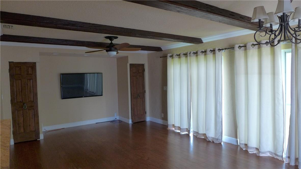 809 North Victoria Park Road Fort Lauderdale, FL 33304 - Photo 8 of 25 a view of a hallway with wooden floor and a ceiling fan