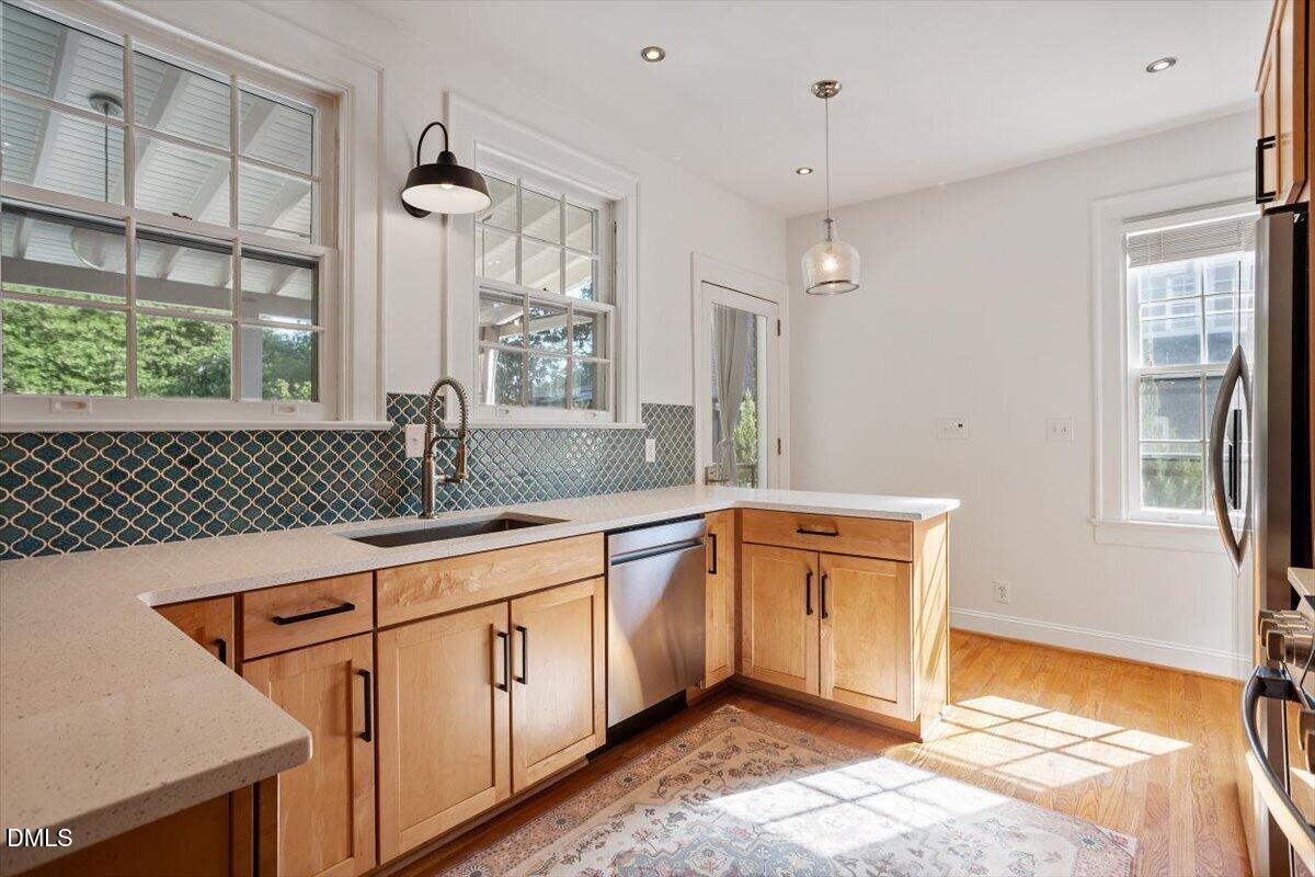 2201 Byrd Street Raleigh, NC 27608 - Photo 19 of 37 a spacious bathroom with a sink a mirror and next to a window