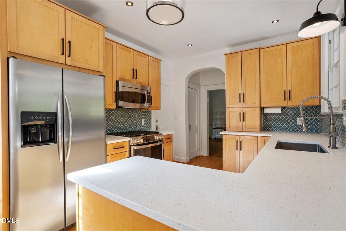2201 Byrd Street Raleigh, NC 27608 - Photo 21 of 37 a kitchen with stainless steel appliances a refrigerator and a stove