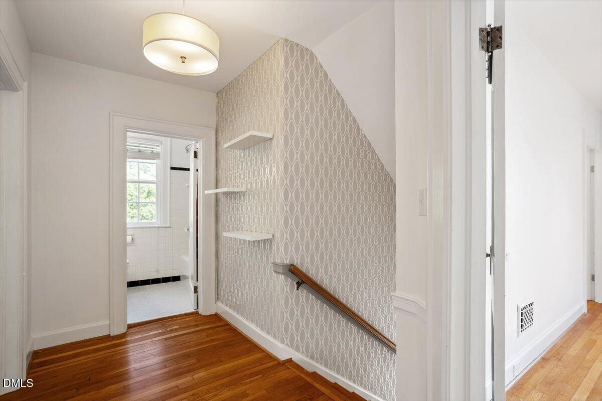 2201 Byrd Street Raleigh, NC 27608 - Photo 22 of 37 a view of a hallway with wooden floor and staircase