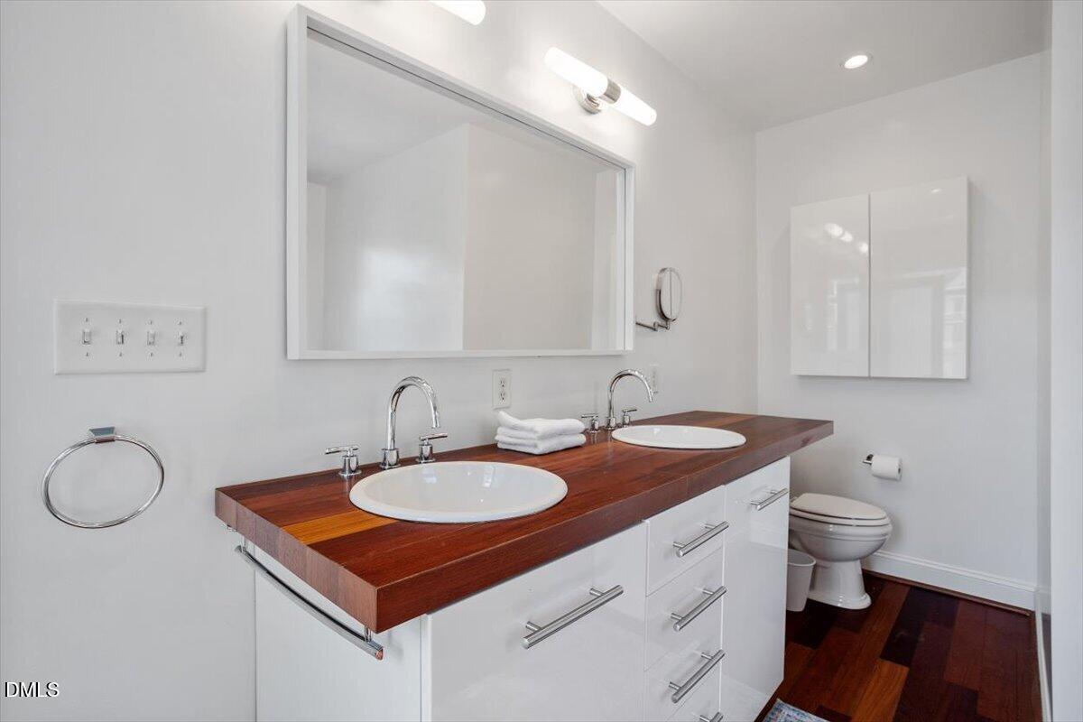 2201 Byrd Street Raleigh, NC 27608 - Photo 27 of 37 a bathroom with a sink toilet and a mirror