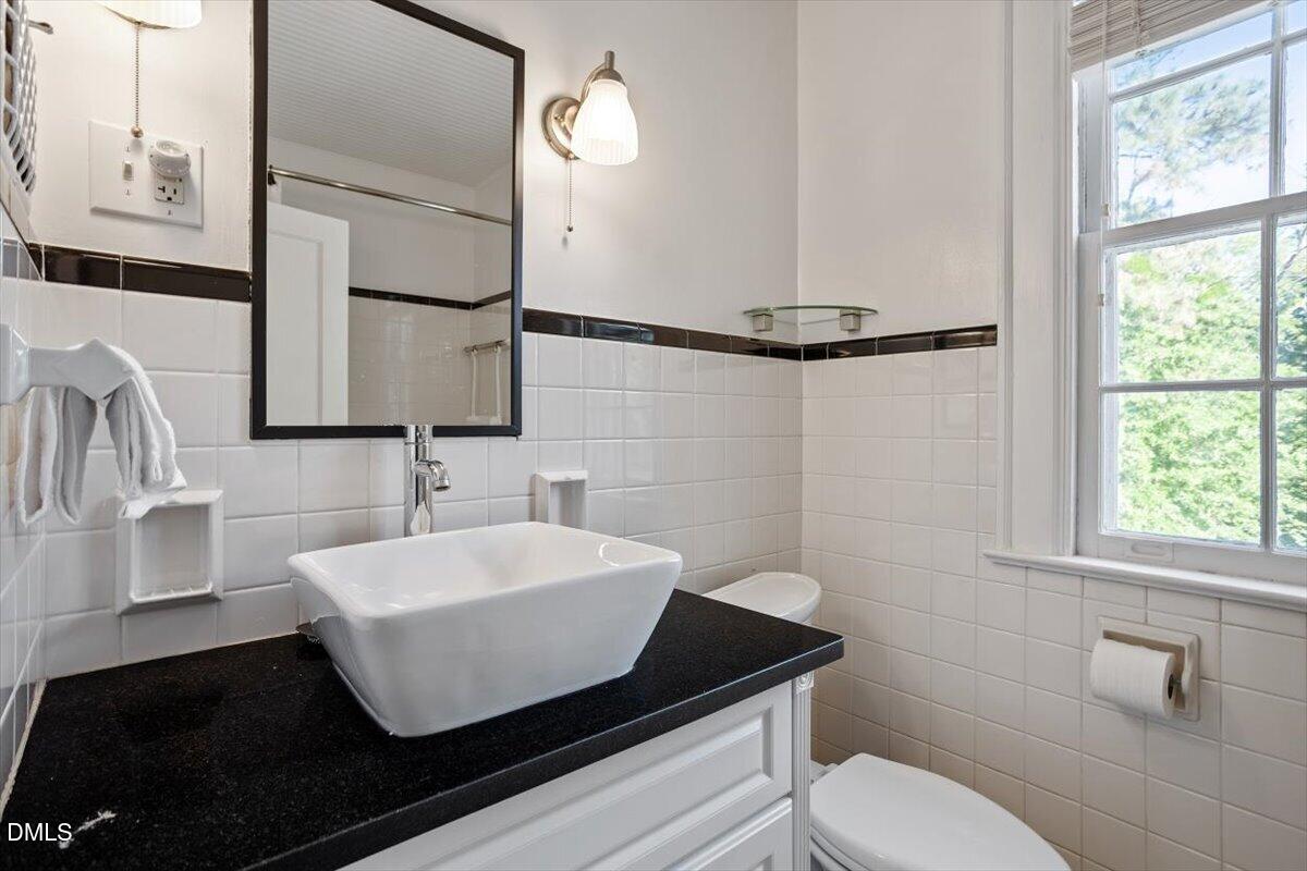 2201 Byrd Street Raleigh, NC 27608 - Photo 33 of 37 a bathroom with a sink and a mirror