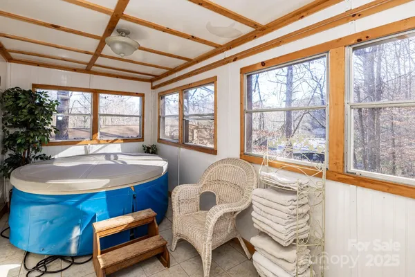 a bedroom with furniture and a large window