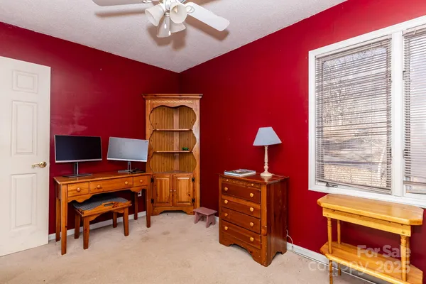a bedroom with furniture and a lamp