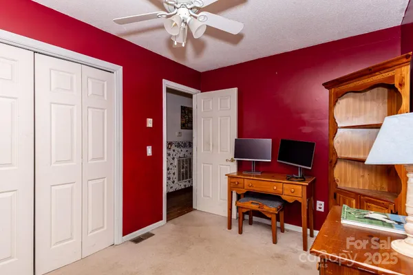 a view of room with furniture and a ceiling fan