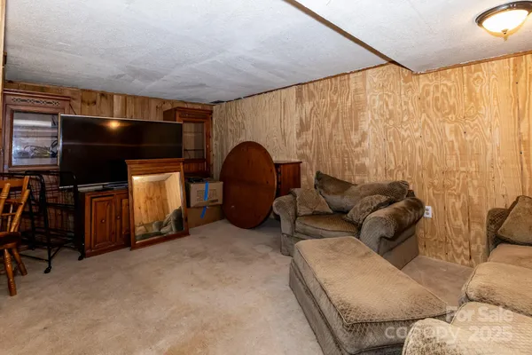 a living room with furniture and a curtain
