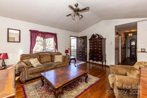 a living room with furniture a rug and a chandelier