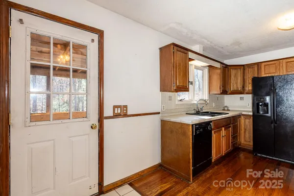 a kitchen with a stove a refrigerator and a sink