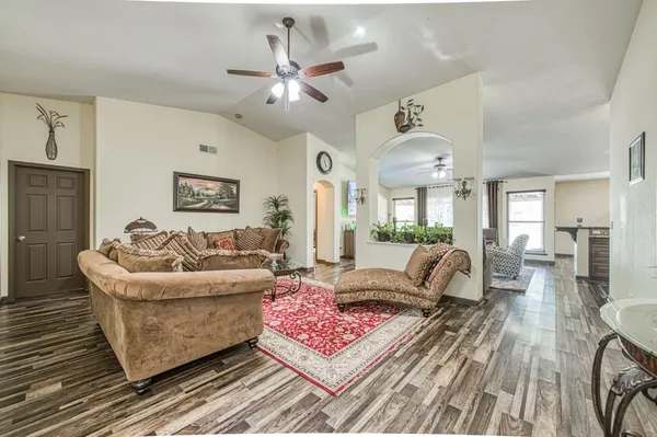 a living room with furniture and a chandelier