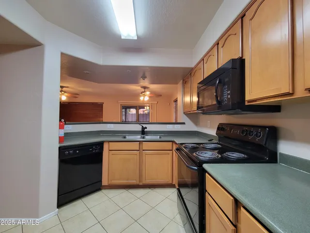 a kitchen with a refrigerator and a stove top oven