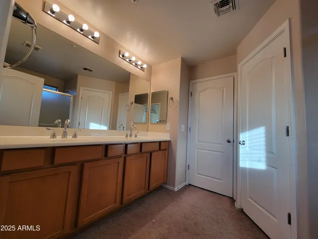a bathroom with a double vanity sink and a mirror