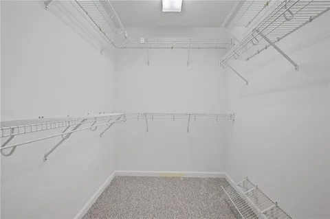 a spacious bathroom with a granite countertop tub sink and mirror