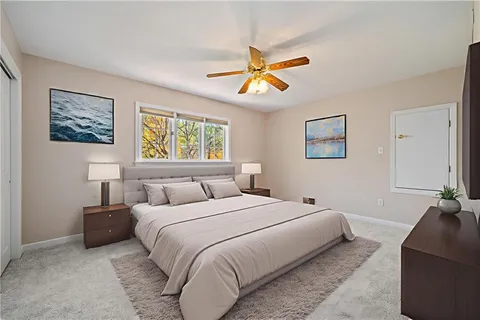 an empty room with a window and a ceiling fan