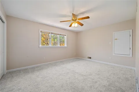 a bedroom with a bed a chandelier and a flat screen tv