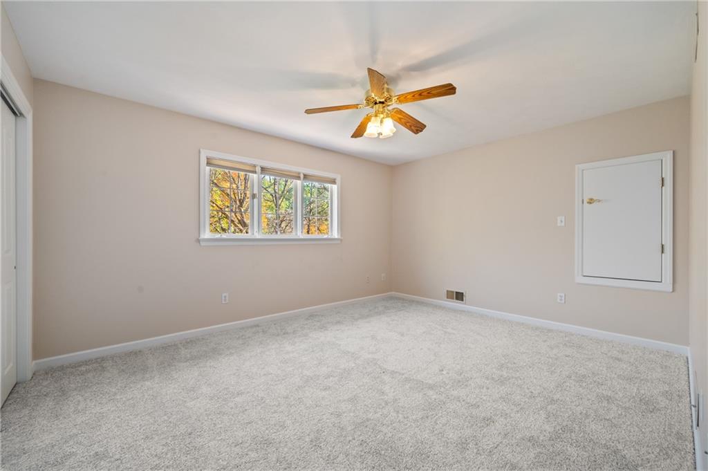 131 Hidden Valley Road Murrysville, PA 15668 - Photo 29 of 50 an empty room with a window and a ceiling fan
