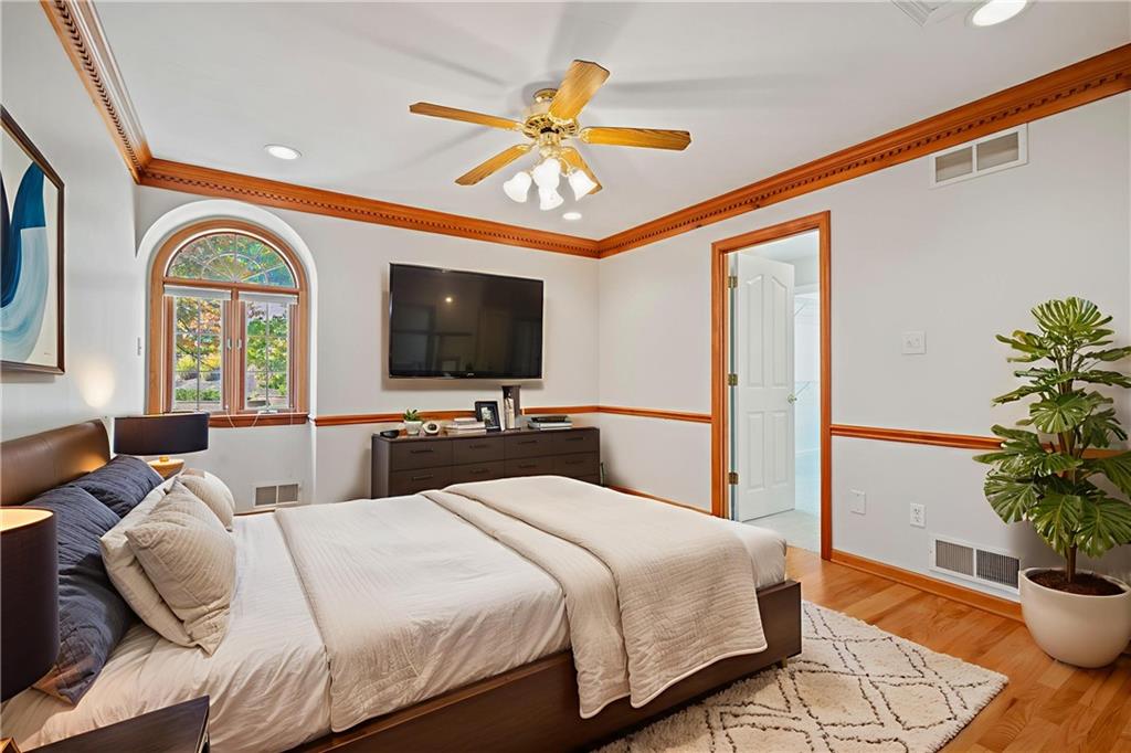 131 Hidden Valley Road Murrysville, PA 15668 - Photo 30 of 50 a bedroom with a bed a chandelier and a flat screen tv