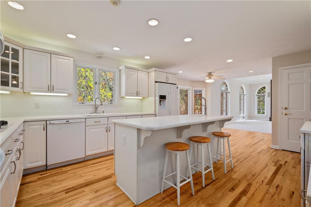 131 Hidden Valley Road Murrysville, PA 15668 - Photo 7 of 50 a kitchen with granite countertop white cabinets and chairs